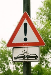 Caution sign depicting a car crash.  Be careful!